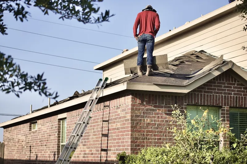 Professional roofer working on a residential roof in Indian Lake